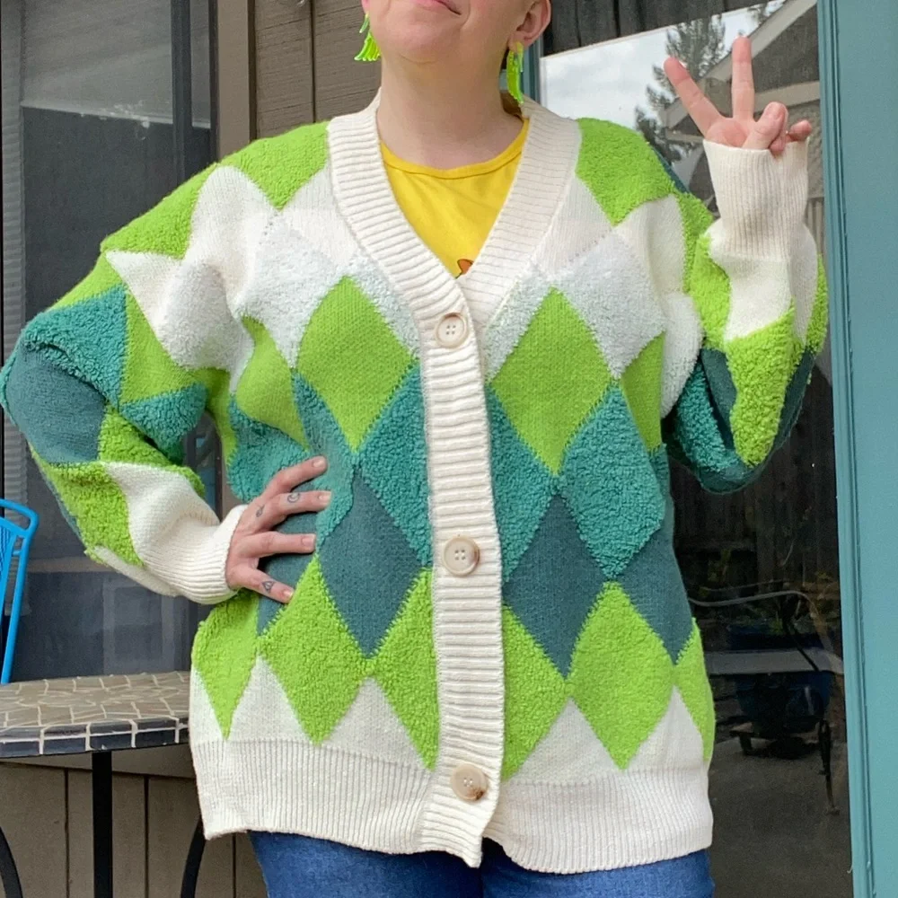 Green and cream harlequin patterned button up sweater